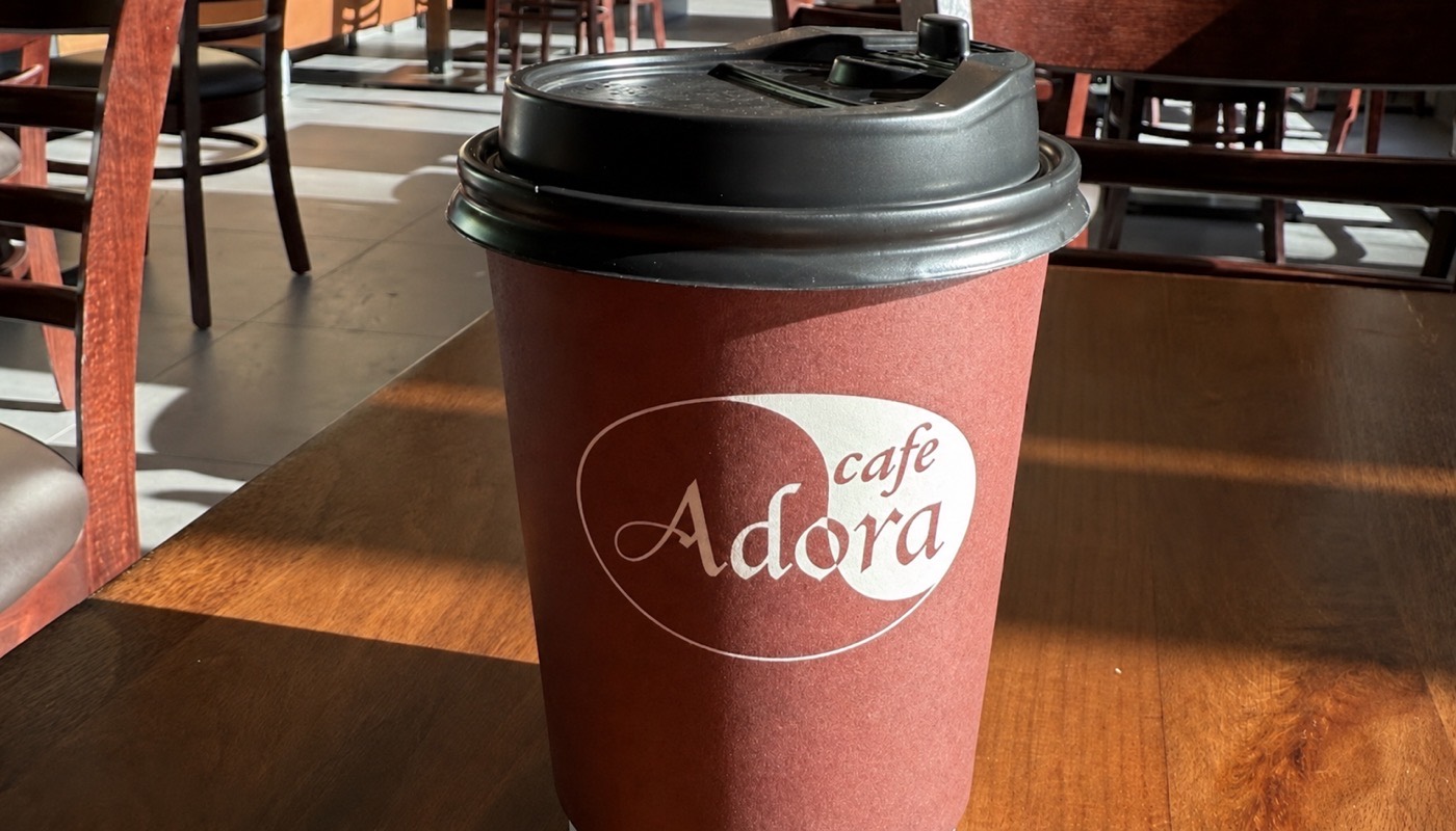 Freshly ground coffee served in a Cafe Adora cup